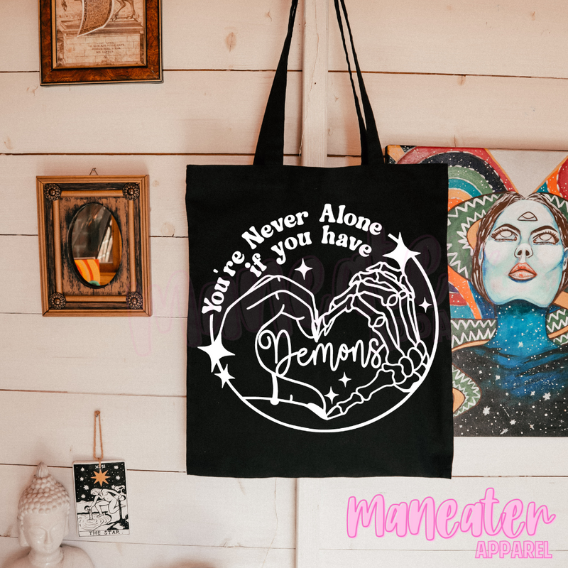 you're never alone if you have demons tote bag